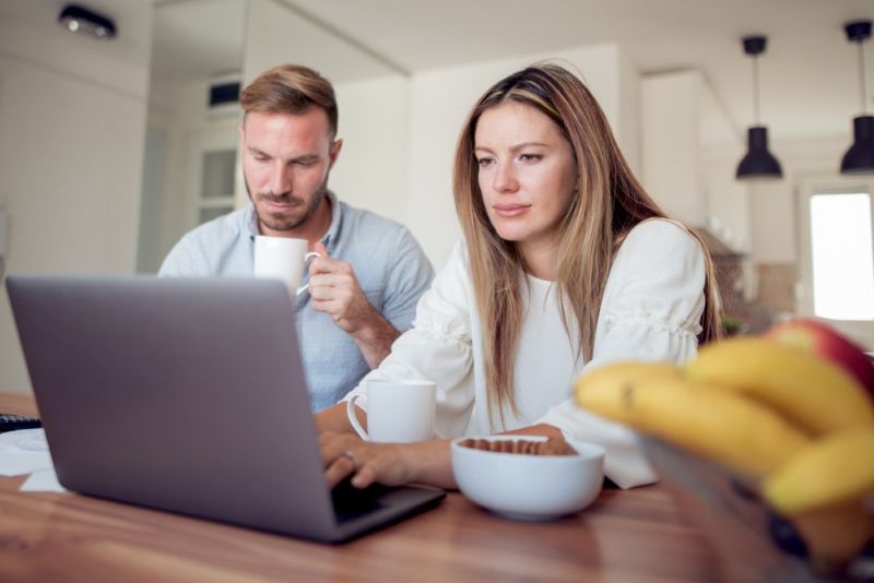 Couple reviewing finances at kitchen table Swift 1